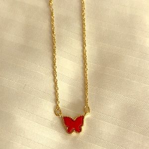 Gold necklace with red butterfly